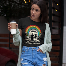 Load image into Gallery viewer, Conservatively Bold "We'll Teach Them" Cotton Crew Tee - Front of tee on a female model holding a coffee standing in a coffee shop