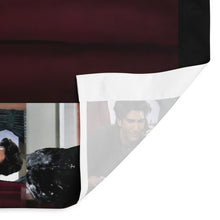 Load image into Gallery viewer, Close-up of a fabric with printed images of a person and a black object.
