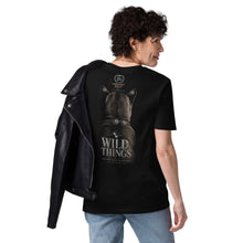 Load image into Gallery viewer, Person wearing a Mountain Lion Turquoise Jewelry Organic Cotton Tee with 'WILD THINGS' printed on the back, standing against a white background.