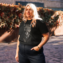 Load image into Gallery viewer, Person wearing a Mountain Lion Turquoise Jewelry Organic Cotton Tee, standing outdoors.