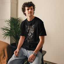 Load image into Gallery viewer, Person wearing a Mountain Lion Turquoise Jewelry Organic Cotton Tee, sitting indoors.