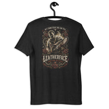 Load image into Gallery viewer, Black t-shirt with white text on a hanger against a white background