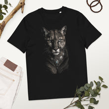 Load image into Gallery viewer, Black Mountain Lion Turquoise Jewelry Organic Cotton Tee on a white surface with greenery
