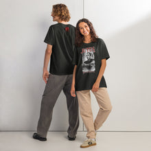 Load image into Gallery viewer, Two people wearing black t-shirts with a design and text on a plain background

