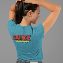Load image into Gallery viewer, Team-Sheldon-Bazina-T-Shirt-worn-byan-attractive-young-woman-showing-back-of-t-shirt-Bazinga
