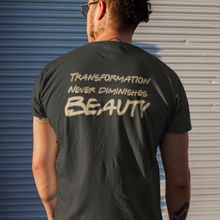 Load image into Gallery viewer, Man standing facing away from view, wearing a &quot;Transformation Never Diminishes Beauty&quot; Black T-Shirt
